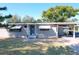 Exterior of the house with a carport, showcasing its cozy charm and inviting curb appeal at 1816 Jasper Drive, Orlando, FL 32807