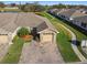 Overhead shot shows the driveway, roof, and lush landscaping of this cozy home at 1821 Christina Lee Ln, St Cloud, FL 34769