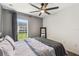 Bedroom with ceiling fan overlooking green space at 1821 Christina Lee Ln, St Cloud, FL 34769