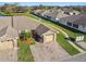 Aerial view of homes with stone accents, a brick driveway and manicured lawns in a quiet neighborhood at 1821 Christina Lee Ln, St Cloud, FL 34769