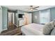 Well-lit main bedroom with ensuite bathroom, view to the water, fan, and vinyl floor at 1821 Christina Lee Ln, St Cloud, FL 34769