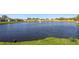 Scenic view of a pond with fountain, surrounded by lush green grass and neighborhood homes at 1821 Christina Lee Ln, St Cloud, FL 34769