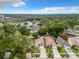 Aerial view of homes surrounded by lush trees and green landscaping within a community at 1970 Larkwood Dr, Apopka, FL 32703