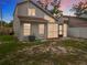 Exterior backyard view showing the home's screened porch at sunset at 1970 Larkwood Dr, Apopka, FL 32703