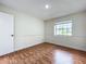 Bedroom showcasing laminate floors, a bright window, and neutral wall color at 1970 Larkwood Dr, Apopka, FL 32703