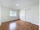 Cozy bedroom with wood laminate floors, window and closet at 1970 Larkwood Dr, Apopka, FL 32703