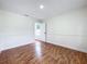 Bedroom featuring wood laminate floors, light paint, and window at 1970 Larkwood Dr, Apopka, FL 32703