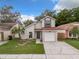 Charming two-story home features a well-maintained lawn and inviting front entrance at 1970 Larkwood Dr, Apopka, FL 32703