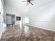 Bright living room featuring tiled floors, ceiling fan, and light-filled windows at 1970 Larkwood Dr, Apopka, FL 32703