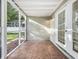 Screened patio with tiled floor and view of fenced yard and pool at 1970 Larkwood Dr, Apopka, FL 32703