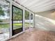 Enclosed porch featuring tile flooring and a screen door leading to the backyard at 1970 Larkwood Dr, Apopka, FL 32703