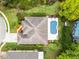 Aerial shot shows the house with a pool, a manicured lawn, and mature landscaping at 2137 Blackjack Oak St, Ocoee, FL 34761