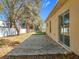 A long patio that runs the length of the house adjoins the backyard at 2339 Foxtree Rd, Tavares, FL 32778