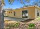 Backyard with a cement patio and view of the home's exterior at 2339 Foxtree Rd, Tavares, FL 32778