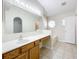 Bathroom vanity featuring a large mirror with Hollywood lights and tiled floors and bath at 2339 Foxtree Rd, Tavares, FL 32778