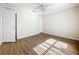 Bedroom with neutral walls, ceiling fan, wood floors, and closet at 2339 Foxtree Rd, Tavares, FL 32778