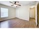 Bedroom with a ceiling fan, wood-look floors, closet, and a window with white blinds at 2339 Foxtree Rd, Tavares, FL 32778