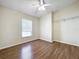 Bedroom features include neutral walls, wood floors and a ceiling fan at 2339 Foxtree Rd, Tavares, FL 32778