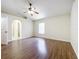 Bedroom with wood floors, neutral paint and an arched doorway at 2339 Foxtree Rd, Tavares, FL 32778