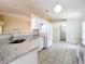 Bright kitchen with granite countertops and new, white appliances at 2339 Foxtree Rd, Tavares, FL 32778