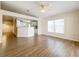 Open living area featuring hardwood floors, a ceiling fan, and large windows for natural light at 2339 Foxtree Rd, Tavares, FL 32778