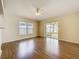 Light-filled living area featuring hardwood floors, a ceiling fan, and sliding glass door access to the outside at 2339 Foxtree Rd, Tavares, FL 32778