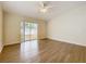 Bright living room features wood floors and sliding glass doors to the backyard at 2339 Foxtree Rd, Tavares, FL 32778