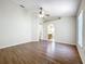 Main bedroom with wood look floors, ceiling fan, and access to the bathroom and secondary room at 2339 Foxtree Rd, Tavares, FL 32778