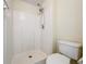 White tiled shower and toilet in the bathroom at 2339 Foxtree Rd, Tavares, FL 32778