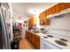 Cozy kitchen equipped with wooden cabinets, essential appliances, and tiled flooring at 2413 Spingarn Ct, Orlando, FL 32811