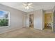 Neutral bedroom featuring two windows, carpeted floors, closet and an ensuite bath at 2508 Grassy Point Dr # 106, Lake Mary, FL 32746