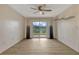 Inviting living room featuring wood-look floors, a ceiling fan, and sliding glass doors at 2508 Grassy Point Dr # 106, Lake Mary, FL 32746