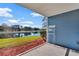 Serene screened patio overlooking a peaceful lake and lush landscaping at 2508 Grassy Point Dr # 106, Lake Mary, FL 32746