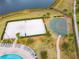 Aerial view of the community volleyball and basketball courts near the resort style pool and lazy river at 2839 Bookmark Dr, Kissimmee, FL 34746