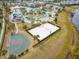 Aerial view of the community volleyball and basketball courts and resort-style pool near a lake at 2839 Bookmark Dr, Kissimmee, FL 34746