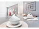 Close-up of kitchen island with white dishes, gray countertops, and open concept design at 2839 Bookmark Dr, Kissimmee, FL 34746