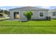 The backyard features a concrete patio and is mostly lawn and well-maintained at 301 E Fiesta Key Loop, Deland, FL 32720