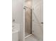 Tiled shower with glass door and a white door in the bathroom at 301 E Fiesta Key Loop, Deland, FL 32720