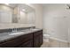 Bathroom featuring double sinks, granite countertops, and a separate shower at 301 E Fiesta Key Loop, Deland, FL 32720