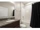 Bathroom featuring a dark vanity and tile flooring as well as a shower and tub at 301 E Fiesta Key Loop, Deland, FL 32720