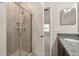 Bathroom showing a tiled shower with glass door and granite countertop at 301 E Fiesta Key Loop, Deland, FL 32720