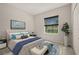 Inviting bedroom with a plush bed, stylish accents, and a window view, creating a cozy retreat at 301 E Fiesta Key Loop, Deland, FL 32720