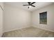 The bedroom features a ceiling fan and a large window at 301 E Fiesta Key Loop, Deland, FL 32720