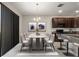 Elegant dining room with a sleek table, stylish chairs, and contemporary lighting, ideal for gatherings at 301 E Fiesta Key Loop, Deland, FL 32720