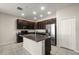 Granite countertops highlight this kitchen with stainless steel appliances and modern fixtures at 301 E Fiesta Key Loop, Deland, FL 32720