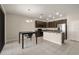 Kitchen featuring an island with sink and granite countertops, dark cabinetry, and stainless steel appliances at 301 E Fiesta Key Loop, Deland, FL 32720