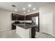 Modern kitchen with granite island, stainless steel appliances, and ample cabinet space, perfect for cooking at 301 E Fiesta Key Loop, Deland, FL 32720