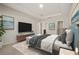 Spacious main bedroom with a large bed, entertainment setup, and a bright ambiance, offering a peaceful escape at 301 E Fiesta Key Loop, Deland, FL 32720