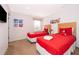 Bright bedroom featuring twin beds with red comforters and Mickey Mouse decor, creating a playful atmosphere at 3021 Red Ginger Rd, Kissimmee, FL 34747