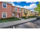 Colorful townhouses featuring landscaped grounds and dedicated parking spaces in a well-maintained community at 3021 Red Ginger Rd, Kissimmee, FL 34747